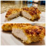 Close-up of baked ranch chicken cut in half, showing juicy white meat and a golden, crispy coating.