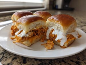 Four delicious buffalo chicken sliders piled high with shredded orange chicken and drizzled with white ranch or blue cheese dressing.