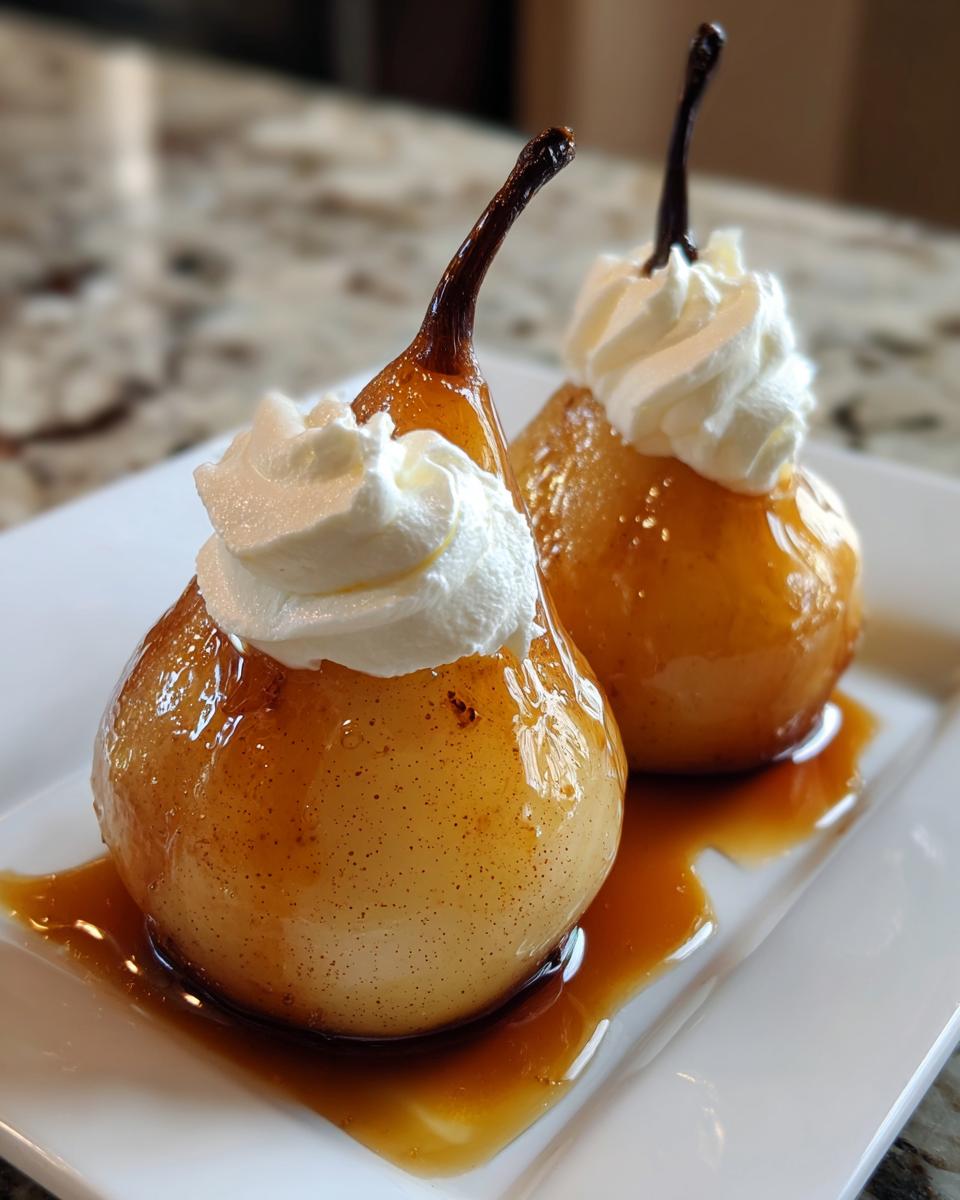 Two beautifully glazed poached pears topped with swirls of whipped cream, served on a white plate with caramel sauce.