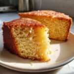 Close-up of a moist slice of condensed milk cake with a golden, slightly caramelized top.