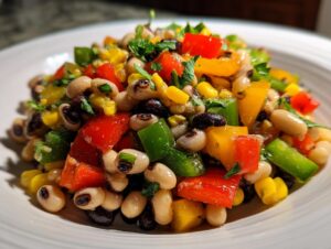 Close-up of colorful cowboy caviar dip featuring black-eyed peas, corn, and diced bell peppers.