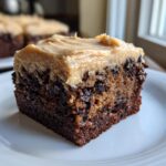 A rich, moist square of banana bread brownies topped with thick peanut butter frosting.