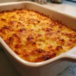 Close-up of a freshly baked potato casserole with a bubbly, golden-brown melted cheese crust.