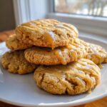 A stack of soft maple brown sugar cookies drizzled generously with a thick caramel glaze.