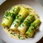 Four pieces of tender braised leeks served in a light cream sauce and topped with fresh chopped chives.