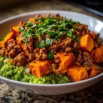 Close-up of a delicious ground turkey sweet potato taco bowl with green rice and cilantro.