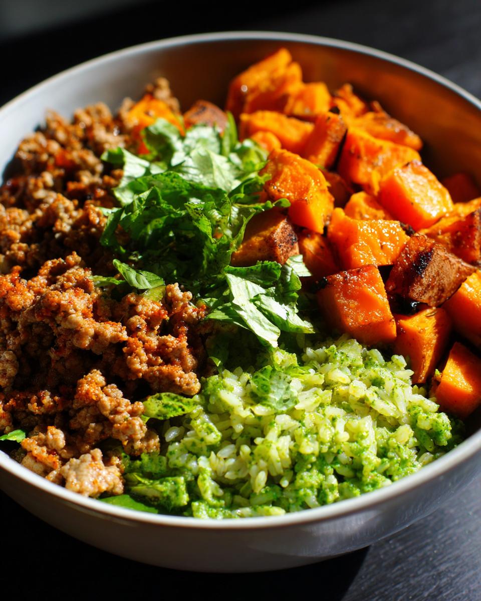 Close-up of a ground turkey sweet potato taco bowl featuring seasoned ground turkey, roasted sweet potatoes, and cilantro-lime rice.
