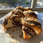 Close-up of sliced chocolate cinnamon crunch knots showing the swirl filling and crunchy topping.