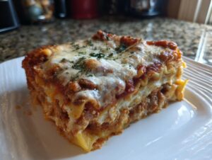 A generous, layered slice of crockpot ravioli lasagna with ricotta, topped with melted cheese and parsley.