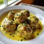 Five perfectly round greek chicken meatballs smothered in a rich, yellow lemon cream sauce and topped with fresh parsley.