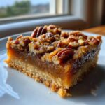 A single serving of a rich keto pecan square recipe with a buttery crust and gooey pecan topping.