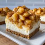 A close-up of a single square of loopy whisk gluten free apple cheesecake bars with a thick apple topping.
