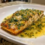 Close-up of a perfectly seared salmon fillet covered in lemon garlic butter sauce, ideal for a keto lemon garlic butter dinner.