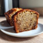 Close-up of a moist slice of the world’s best banana bread showing its rich, brown crumb texture.
