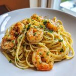 Close-up of delicious Shrimp scampi served over linguine pasta, coated in a buttery garlic sauce and topped with parsley.
